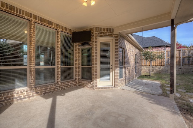 view of patio featuring fence