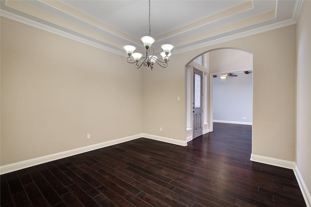 empty room featuring a raised ceiling, dark hardwood / wood-style flooring, ceiling fan with notable chandelier, and ornamental molding