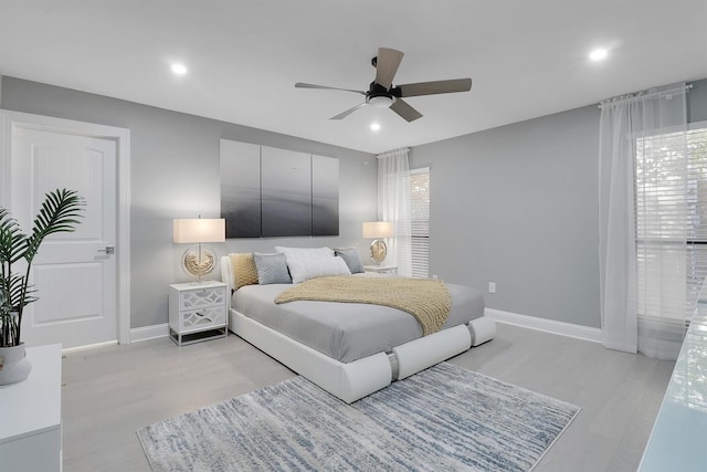 bedroom with ceiling fan and light wood-type flooring