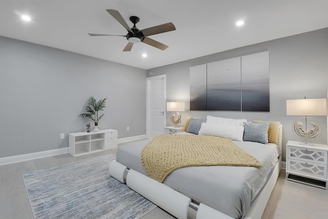 bedroom with ceiling fan and light hardwood / wood-style flooring