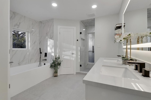 bathroom featuring tile patterned flooring, shower with separate bathtub, and vanity