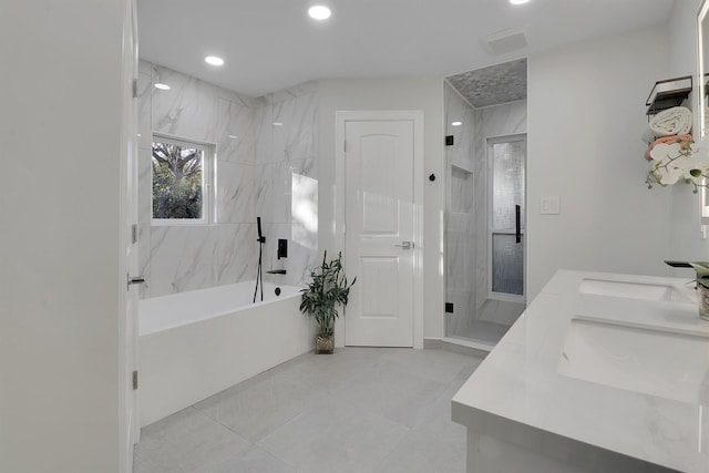 bathroom featuring tile patterned flooring, vanity, and separate shower and tub