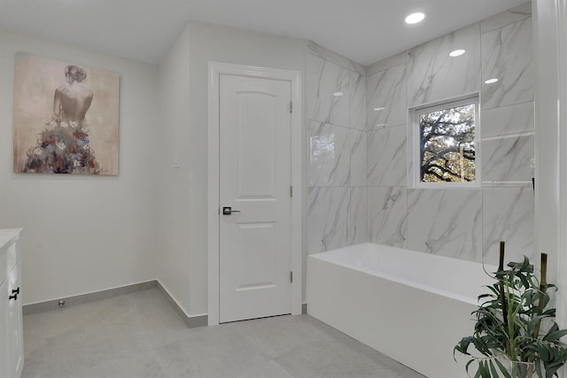 bathroom featuring a tub to relax in and tile patterned flooring