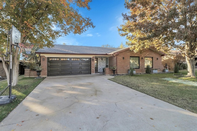 ranch-style house featuring a garage, a front lawn, concrete driveway, and brick siding