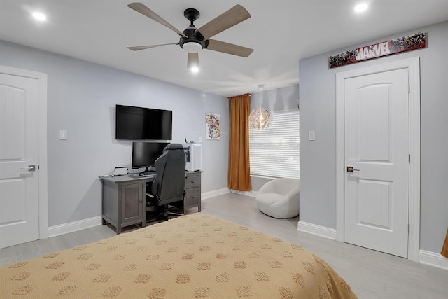 bedroom with ceiling fan and light hardwood / wood-style floors