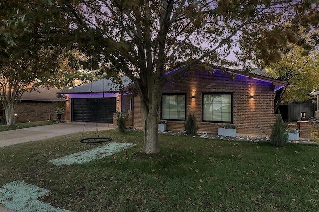 ranch-style house with a garage and a front lawn