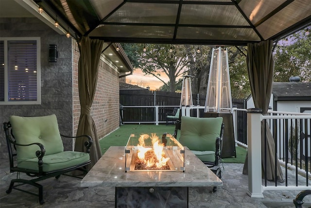 patio terrace at dusk with a gazebo and an outdoor fire pit