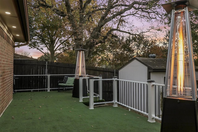 yard at dusk with a storage shed