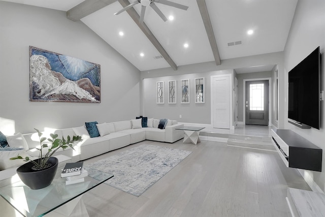 living room featuring ceiling fan, lofted ceiling with beams, and light hardwood / wood-style floors