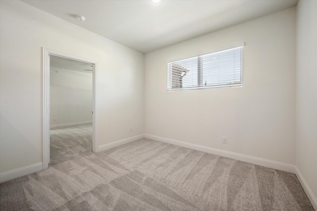 unfurnished room with light carpet