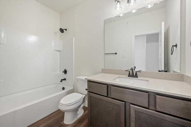 full bathroom with hardwood / wood-style flooring, vanity, tub / shower combination, and toilet