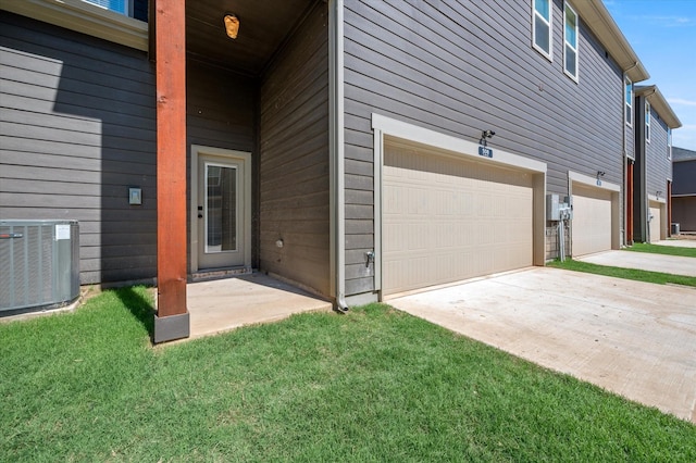 view of side of home featuring a garage, a yard, and central air condition unit