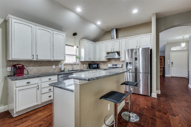 kitchen featuring a kitchen island, white cabinetry, appliances with stainless steel finishes, and hanging light fixtures