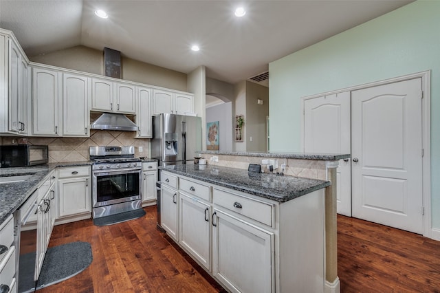 kitchen with white cabinetry, appliances with stainless steel finishes, dark hardwood / wood-style flooring, and dark stone counters