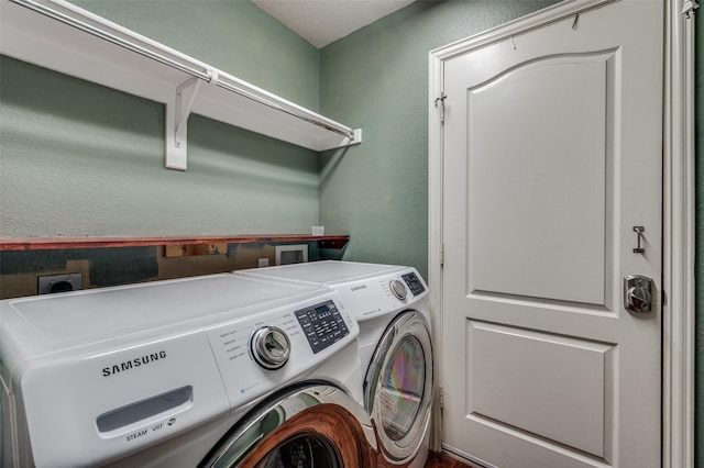 washroom featuring washing machine and clothes dryer