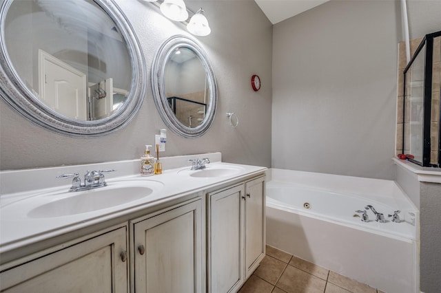 bathroom with vanity, a bath, and tile patterned floors