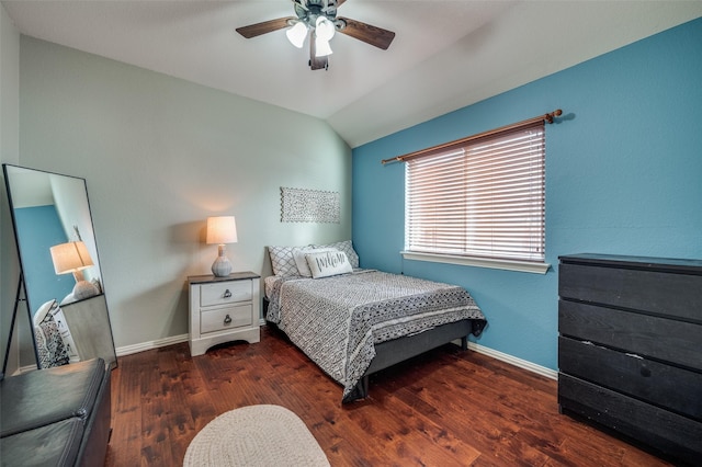 bedroom with dark hardwood / wood-style flooring, vaulted ceiling, and ceiling fan