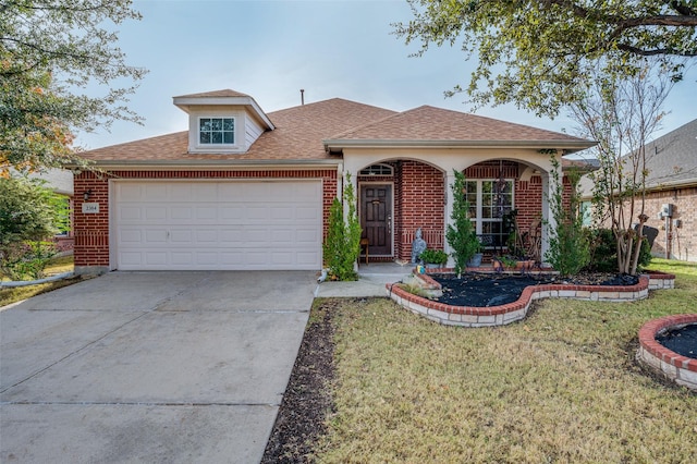 view of front of home with a garage and a front lawn