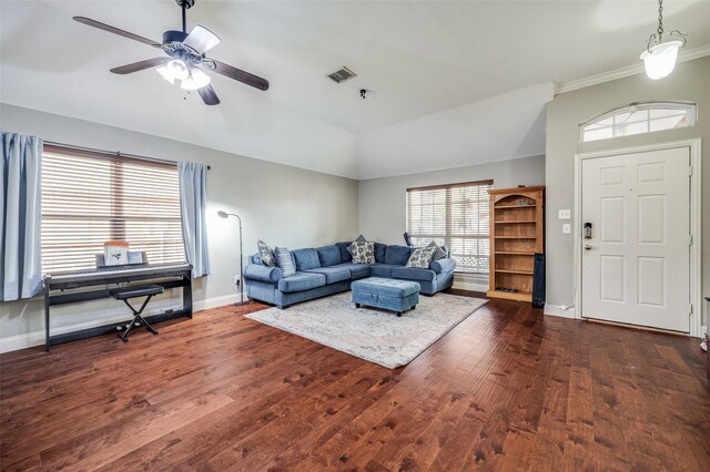 living room with dark hardwood / wood-style floors, ceiling fan, lofted ceiling, and crown molding