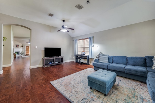 living room with vaulted ceiling, dark hardwood / wood-style floors, and ceiling fan