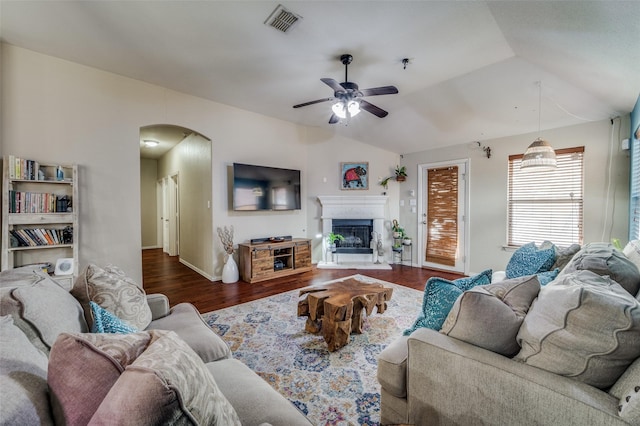 living room with lofted ceiling, dark hardwood / wood-style floors, and ceiling fan