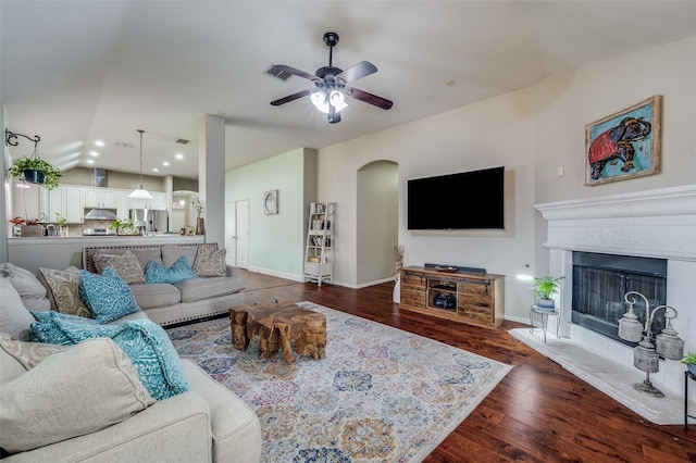 living room with ceiling fan, lofted ceiling, and dark hardwood / wood-style flooring