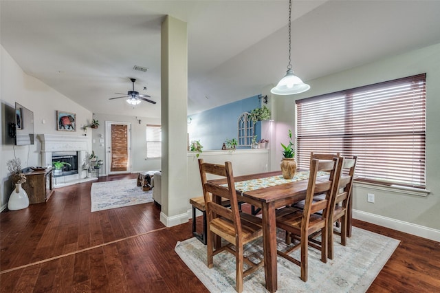 dining room featuring vaulted ceiling, dark hardwood / wood-style floors, and ceiling fan