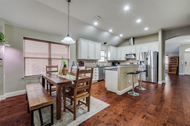 dining room featuring lofted ceiling and dark hardwood / wood-style flooring