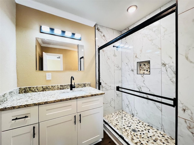 1601 Ficklin Ave, Corsicana, TX 75110 - full bath featuring ornamental molding, vanity, a textured wall, and a marble finish shower