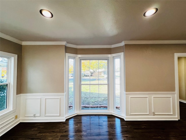 entryway with ornamental molding, dark wood-type flooring, and a wealth of natural light