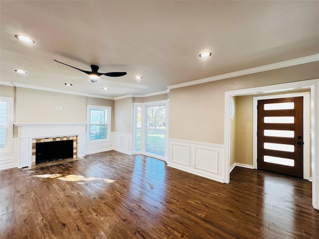 1601 Ficklin Ave, Corsicana, TX 75110 - unfurnished living room with dark wood-type flooring, a decorative wall, a ceiling fan, and ornamental molding