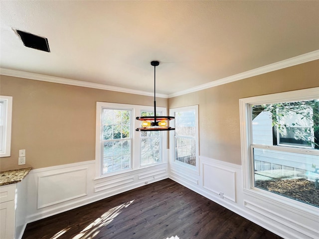 1601 Ficklin Ave, Corsicana, TX 75110 - unfurnished dining area with a decorative wall, dark wood-style floors, crown molding, and wainscoting