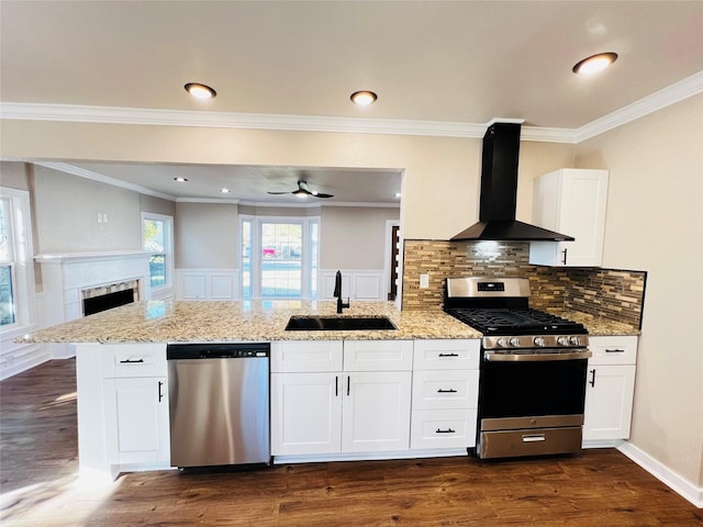 1601 Ficklin Ave, Corsicana, TX 75110 - kitchen with wall chimney exhaust hood, a sink, appliances with stainless steel finishes, light stone countertops, and dark wood-type flooring