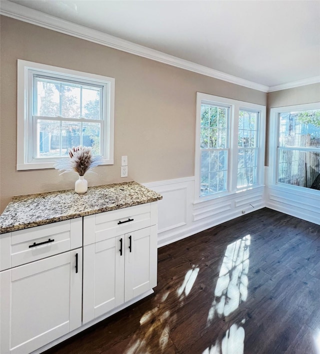 1601 Ficklin Ave, Corsicana, TX 75110 - unfurnished dining area featuring a wealth of natural light, dark wood-style floors, and ornamental molding