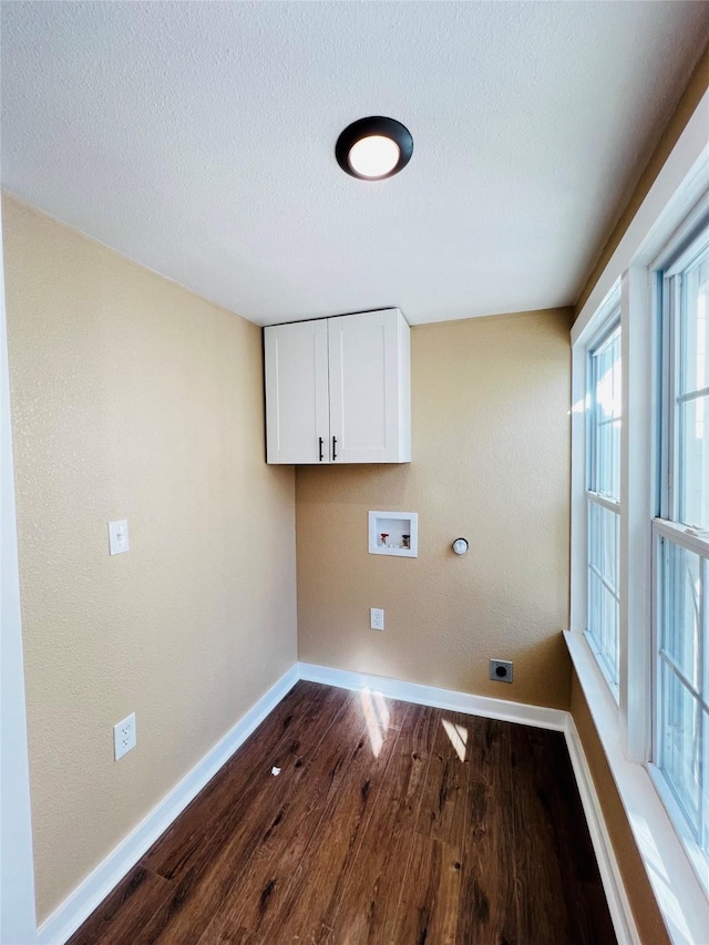 clothes washing area featuring cabinets, a textured ceiling, hookup for a washing machine, electric dryer hookup, and hardwood / wood-style floors