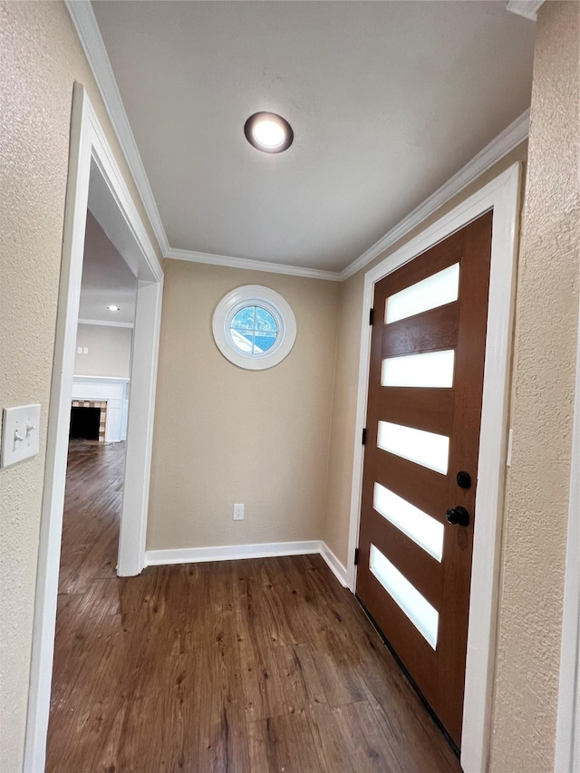 1601 Ficklin Ave, Corsicana, TX 75110 - entrance foyer with a textured wall, ornamental molding, baseboards, and dark wood-style floors