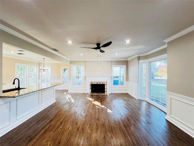 1601 Ficklin Ave, Corsicana, TX 75110 - unfurnished living room with a decorative wall, plenty of natural light, and dark wood-style flooring