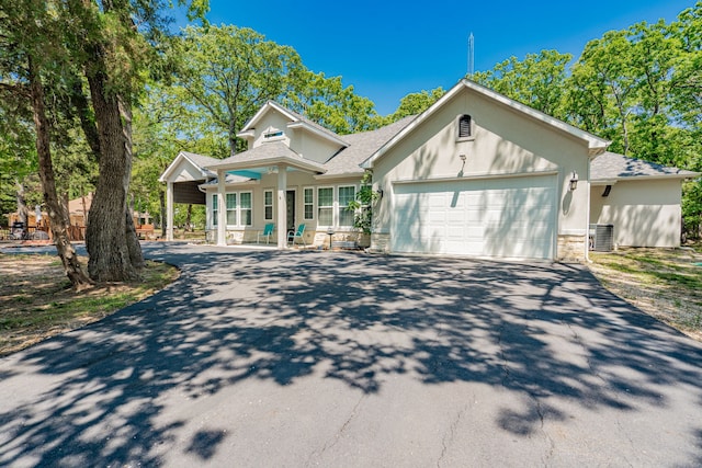 view of front of property with a carport and a garage