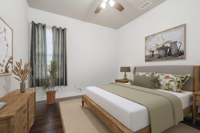 bedroom with dark hardwood / wood-style floors and ceiling fan