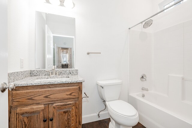 full bathroom featuring vanity, wood-type flooring, bathtub / shower combination, and toilet