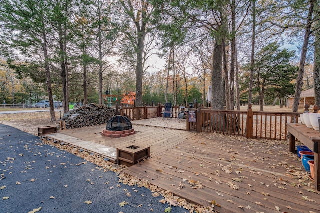 wooden deck with an outdoor fire pit