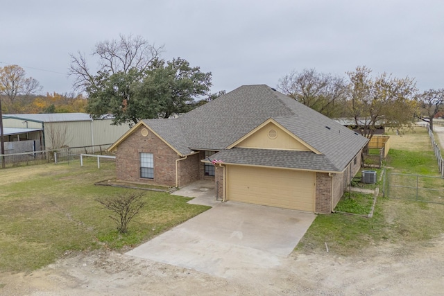 view of front facade with a front yard, a garage, and cooling unit