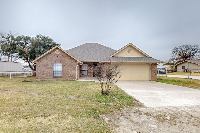 ranch-style house featuring a front yard and a garage