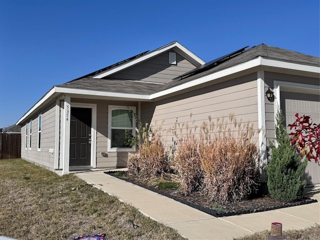 exterior space with solar panels and a garage