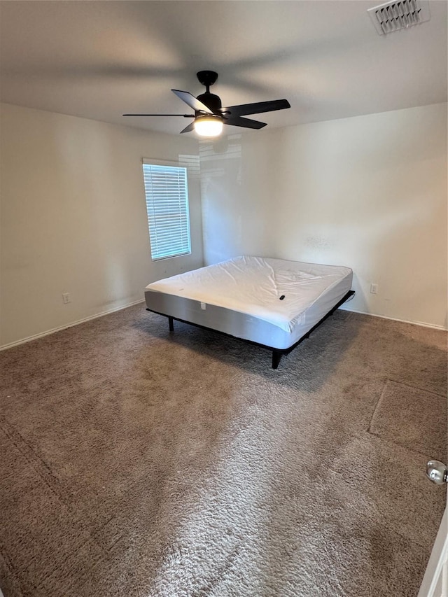 unfurnished bedroom featuring ceiling fan and carpet