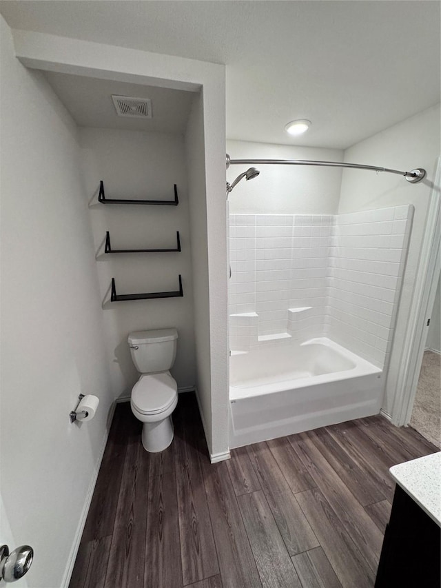 full bathroom with vanity, hardwood / wood-style floors, shower / tub combination, and toilet