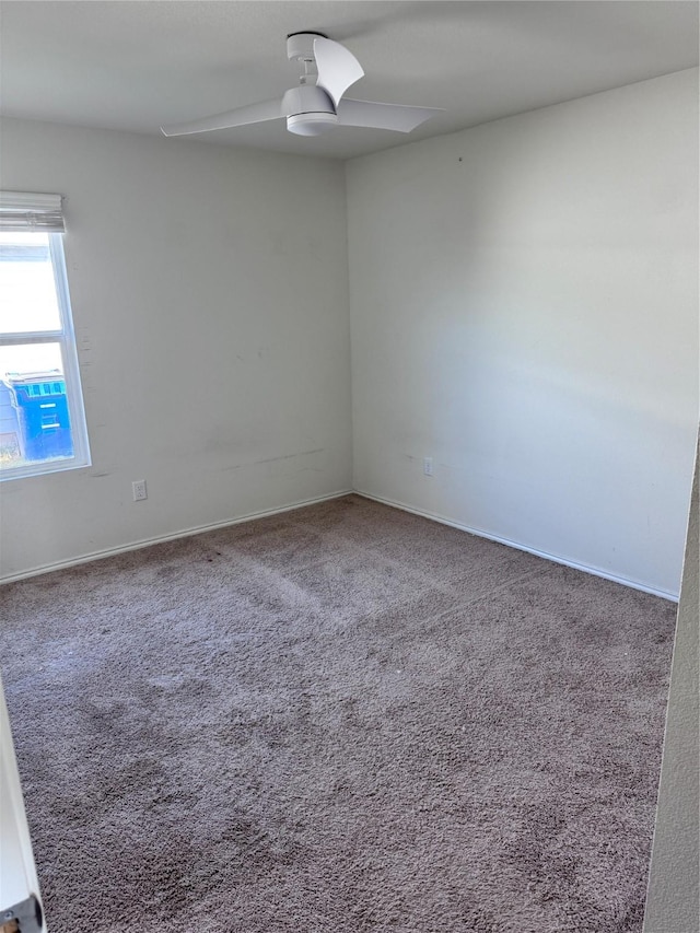 empty room featuring carpet and ceiling fan