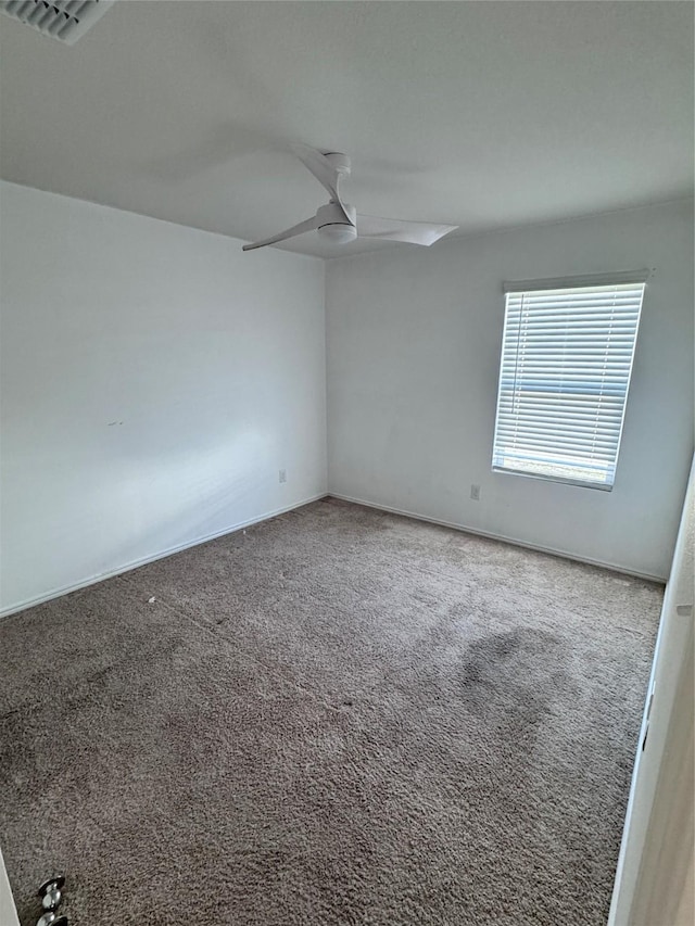 unfurnished room with ceiling fan and carpet floors