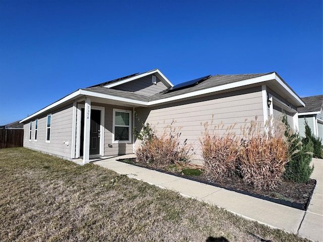 view of home's exterior featuring a yard and solar panels