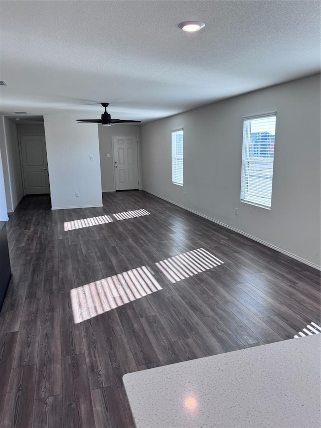 unfurnished living room featuring a healthy amount of sunlight and a textured ceiling